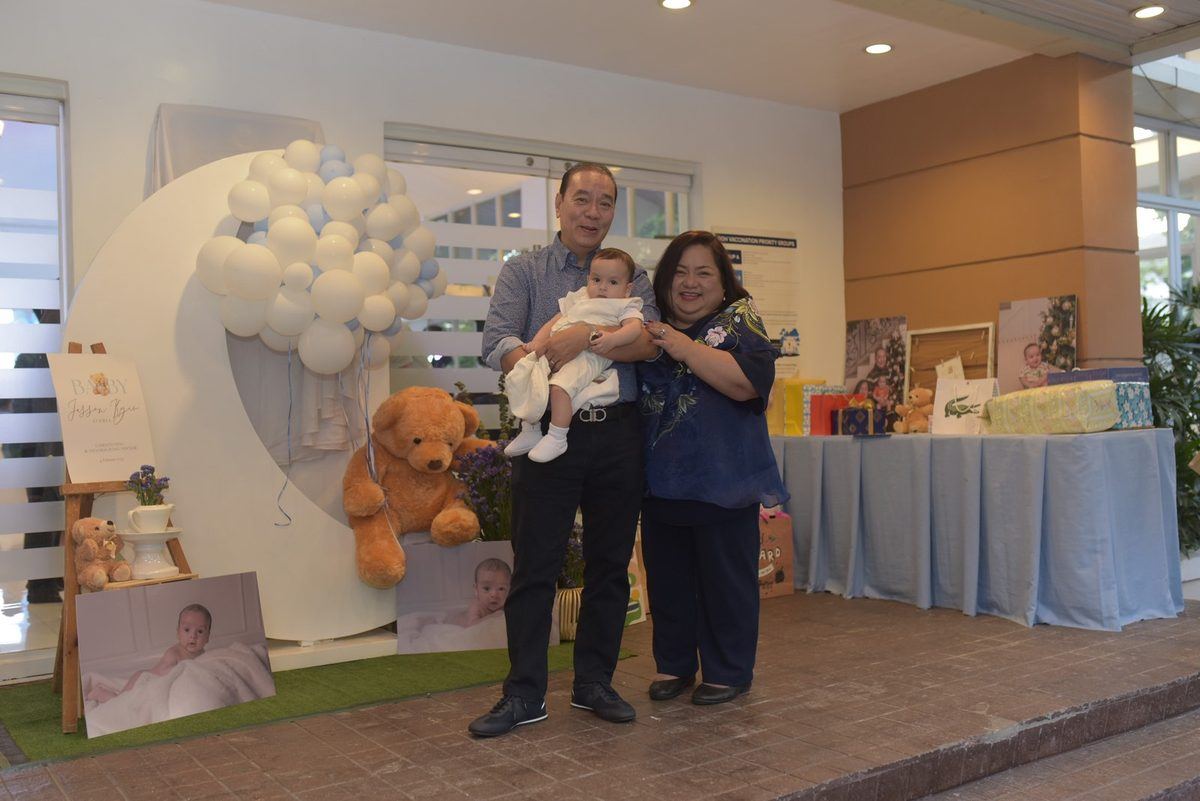Averia family from the Philippines holding Baby Jesson at his christening — family story